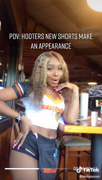 I'm a retired Hooters girl - I tried on my old uniforms including a  military-themed look with camo booty shorts