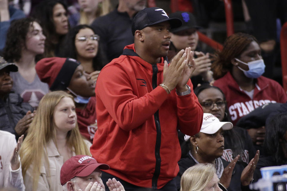 Denver Broncos quarterback Russell Wilson cheers during the second half of a college basketball game between Stanford and Maryland in the Sweet 16 round of the NCAA tournament, Friday, March 25, 2022, in Spokane, Wash. Wilson's sister, Stanford guard Anna Wilson, was playing in the game. (AP Photo/Young Kwak)