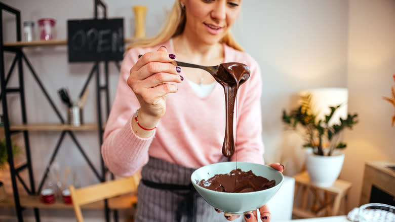 Woman mixing melted chocolate