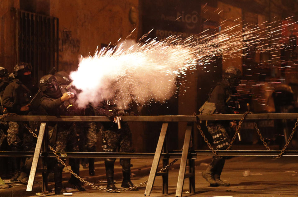 Police fire tear gas at demonstrators during a protest against President Evo Morales' reelection, in La Paz, Bolivia, Thursday, Nov. 7, 2019. The United Nations on Thursday urged Bolivia's government and opposition to restore "dialogue and peace" after a third person was killed in street clashes that erupted after a disputed presidential election on Oct. 20. (AP Photo/Juan Karita)