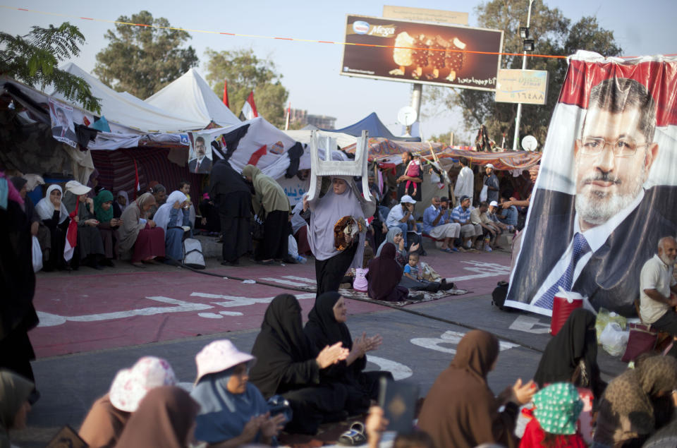 Supporters of Egypt's ousted President Mohammed Morsi sit outside Rabaah al-Adawiya mosque, where protesters have installed a camp and hold daily rallies at Nasr City in Cairo, Egypt, Thursday, Aug. 1, 2013. (AP Photo/Khalil Hamra)