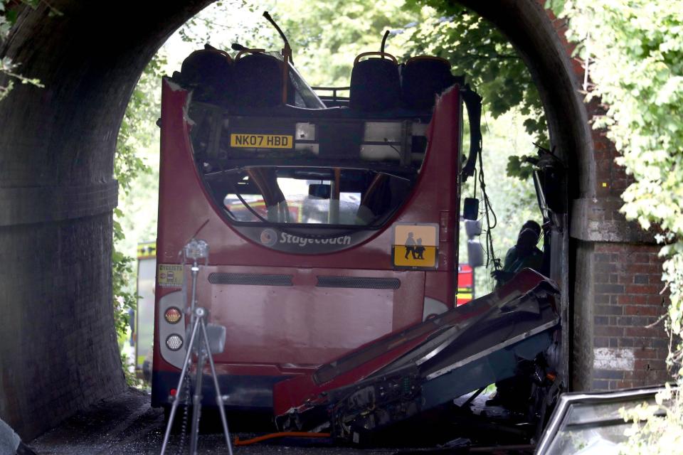 The roof of the bus was sheared off as it crashed into the bridge (PA)