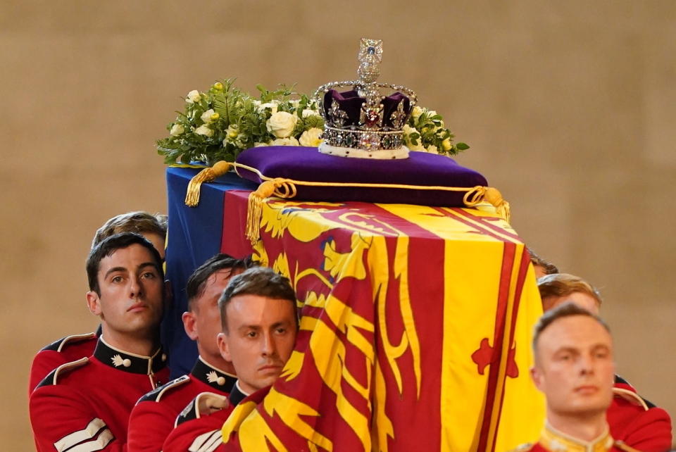 The bearer party carries the coffin of Queen Elizabeth II into Westminster Hall, London, Wednesday Sept. 14, 2022. The Queen will lie in state in Westminster Hall for four full days before her funeral on Monday Sept. 19. ( Jacob King/Pool via AP)