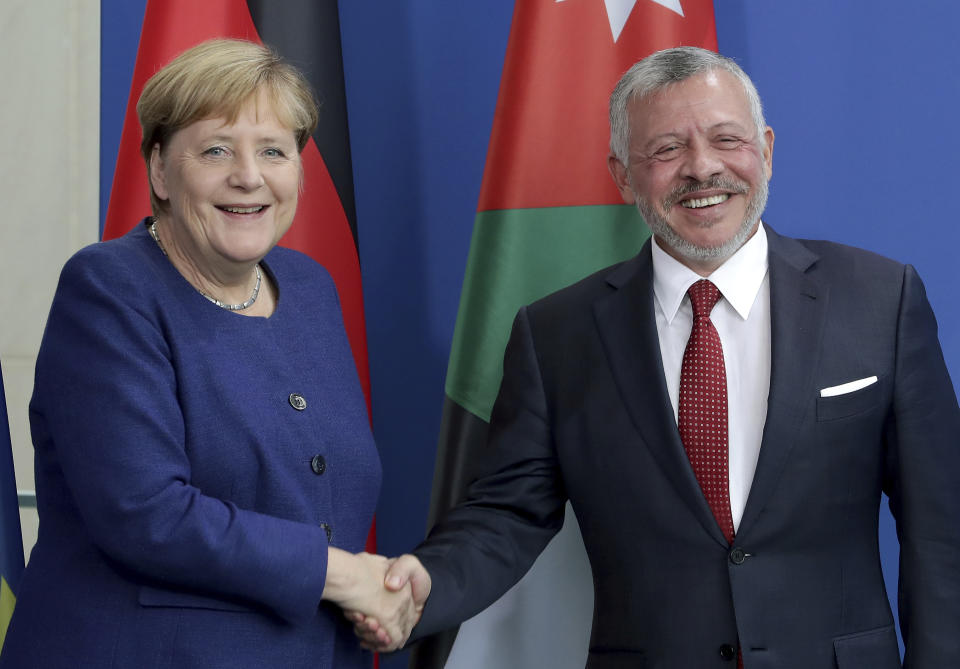 German Chancellor Angela Merkel, left, and Jordan's King Abdullah II, right, shake hands after a joint press conference as part of a meeting at the Chancellery in Berlin, Germany, Tuesday, Sept. 17, 2019. (AP Photo/Michael Sohn)