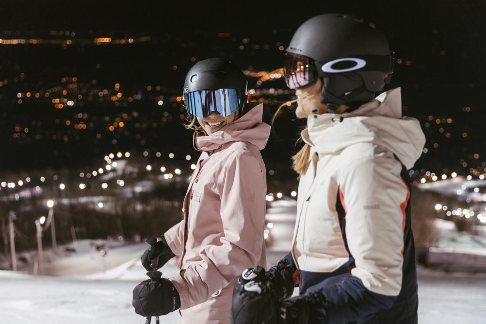 Pair of friends night skiing at Bromont in Quebec
