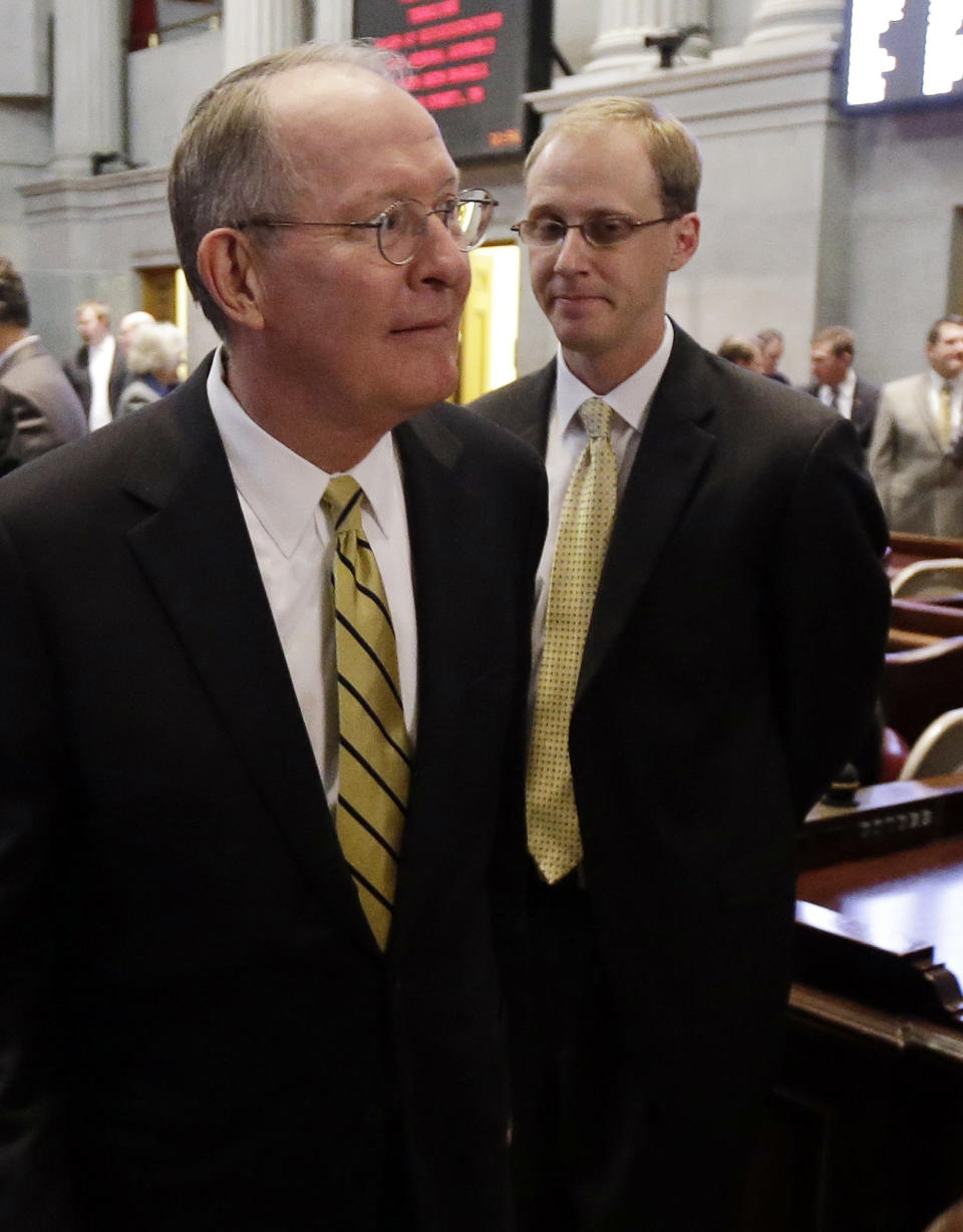 FILE This Jan. 9, 2013 file photo shows Sen. Lamar Alexander, R-Tenn., left, leaving the Tennessee House of Representatives chamber with his then-chief of staff, Ryan Loskarn, in Nashville, Tenn. Loskarn has been found dead in Maryland, just weeks after the former staffer's arrest on child pornography charges. The Carroll County Sheriff's office said on its website Friday that Ryan Loskarn was found dead Thursday in Sykesville, Md. Deputies say the preliminary investigation shows Loskarn may have committed suicide. (AP Photo/Mark Humphrey, File)