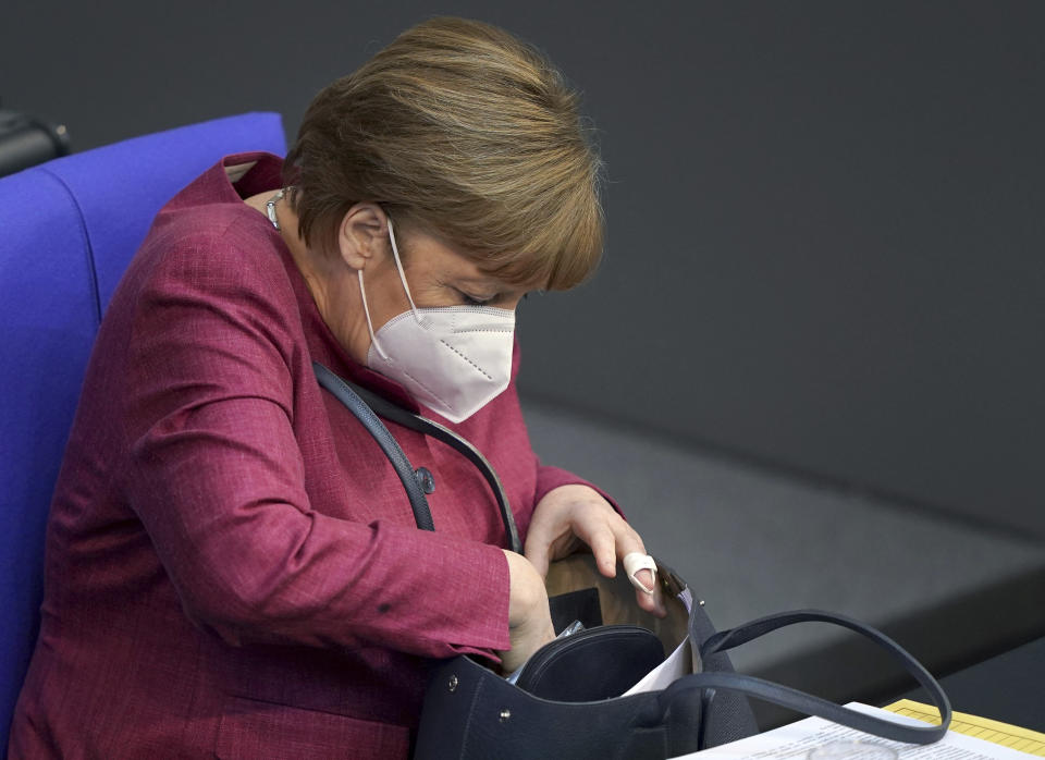 German Chancellor Angela Merkel arrives for a meeting of the German federal parliament, Bundestag, at the Reichstag building in Berlin, Germany, Wednesday, April 21, 2021. (AP Photo/Michael Sohn)