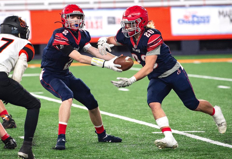 Grady Stark (2) passes the ball to Zander Arnold (20) as Chenango Forks captured the Class C NYSPHSAA State Football Championship over Schuylerville at the Carrier Dome in Syracuse on Friday, Dec. 3, 2021. The final score was 0-21. 