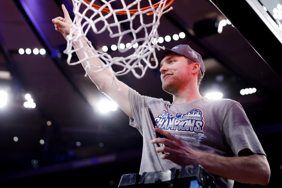 NEW YORK, NEW YORK - MARCH 16: Cam Spencer #12 of the Connecticut Huskies reacts after cutting a piece of the net to celebrate his team's against the Marquette Golden Eagles during the Big East Basketball Tournament Final at Madison Square Garden on March 16, 2024 in New York City. The Huskies won 73-57. (Photo by Sarah Stier/Getty Images)