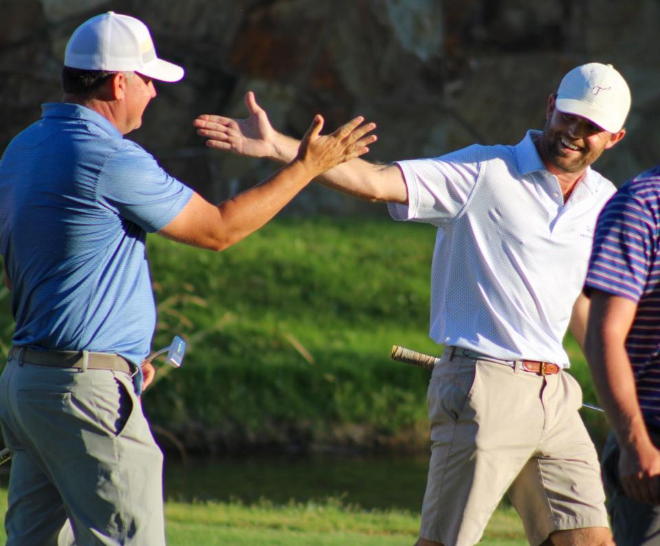 Alex Ellis (right) and Cory Bull celebrate after securing the championship during the final day of the Hillcrest Swinger golf tournament on Sunday, June 26, 2022.