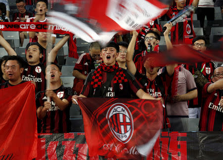 FILE PHOTO: Chinese fans of AC Milan sing before their team's International Champions Cup friendly match against Inter Milan in Shenzhen, China, July 25, 2015. REUTERS/Bobby Yip/File Photo