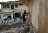 <p>Kaipo Popa secures plywood to protect windows on a home in preparation for Hurricane Lane, Wednesday, Aug. 22, 2018, in Kapolei, Hawaii. (Photo: John Locher/AP) </p>