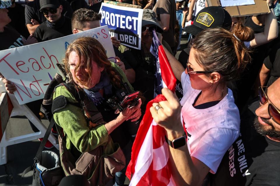 <div class="inline-image__caption"><p>Protesters surround Kelly Stuart as she struggles to leave the area after photographing them during demonstrations outside the Glendale Unified School District Board of Education.</p></div> <div class="inline-image__credit">Robert Gauthier</div>