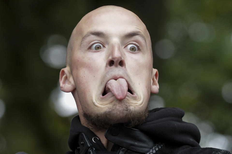 A member of the Tu Tangata motorcycle club reacts as he performs a haka outside the Al Noor mosque in Christchurch, New Zealand, Sunday, March 15, 2020. A national memorial in New Zealand to commemorate the 51 people who were killed when a gunman attacked two mosques one year ago has been canceled due to fears over the new coronavirus. (AP Photo/Mark Baker)