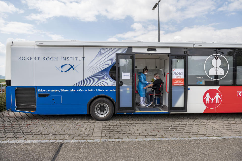 KUPFERZELL, GERMANY - MAY 20: A medical worker wearing a protective suit takes a blood sample from a local resident during a study to analyse the presence of Covid-19 antibodies on May 20, 2020 in Kupferzell, Germany. The study has been launched in cooperation with the Robert Koch Institute, Germany's main agency for the prevention of the spread of infectious diseases, and seeks to gain data on what portion of the local population carries the Covid-19 antibody in communities where coronavirus infection has spiked. Kupferzell, where approximately 2,000 residents will take part, is the first community to undergo the study, and will be followed by three more communities in coming weeks and months. (Photo by Thomas Lohnes/Getty Images)