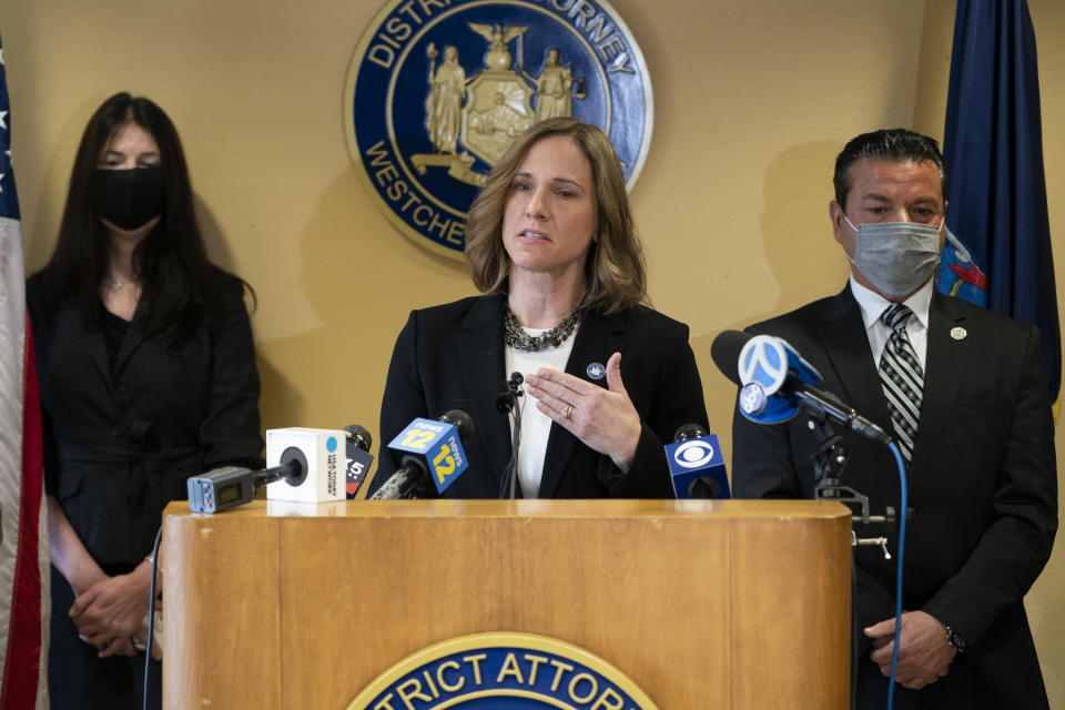 Westchester County District Attorney Miriam Rocah, center, speaks alongside New York State Police Investigator Joseph Becerra, right, during a news conference to announce the release of an investigative report on Robert Durst, the real estate heir and convicted murderer who died while under indictment in the 1982 disappearance of his first wife, 29-year-old Kathleen Durst, Wednesday, Jan. 19, 2022, in White Plains, N.Y. (AP Photo/John Minchillo)