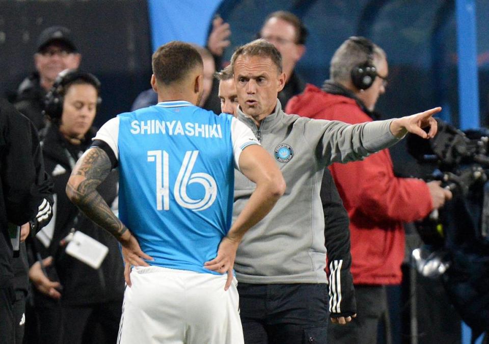 Charlotte FC’s #16, Andre Shinyashiki gets some instructions from head coach, Christian Lattanzio, prior to him being inserted into the match during the second half. Charlotte lost to the New England Revolution 1-0. Charlotte FC faced off against the New England Revolution in the season opener at Bank of America Stadium during a Saturday evening game on Feb. 25, 2023.