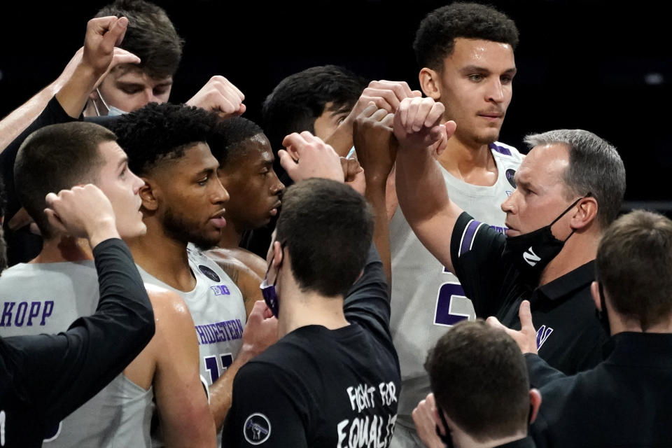 Northwestern head coach Chris Collins, right, cheers on his team during the first half of an NCAA college basketball game against Pittsburgh in Evanston, Ill., Wednesday, Dec. 9, 2020. (AP Photo/Nam Y. Huh)