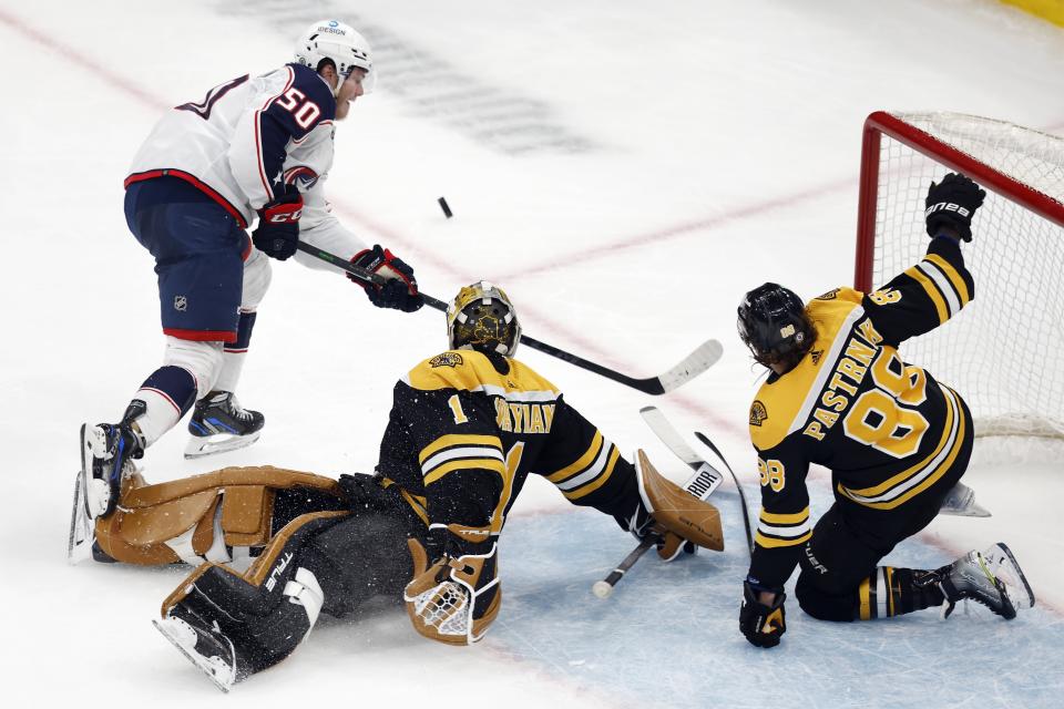 Boston Bruins' Jeremy Swayman (1) blocks a shot by Columbus Blue Jackets' Eric Robinson (50) during the second period of an NHL hockey game, Saturday, Dec. 17, 2022, in Boston. (AP Photo/Michael Dwyer)