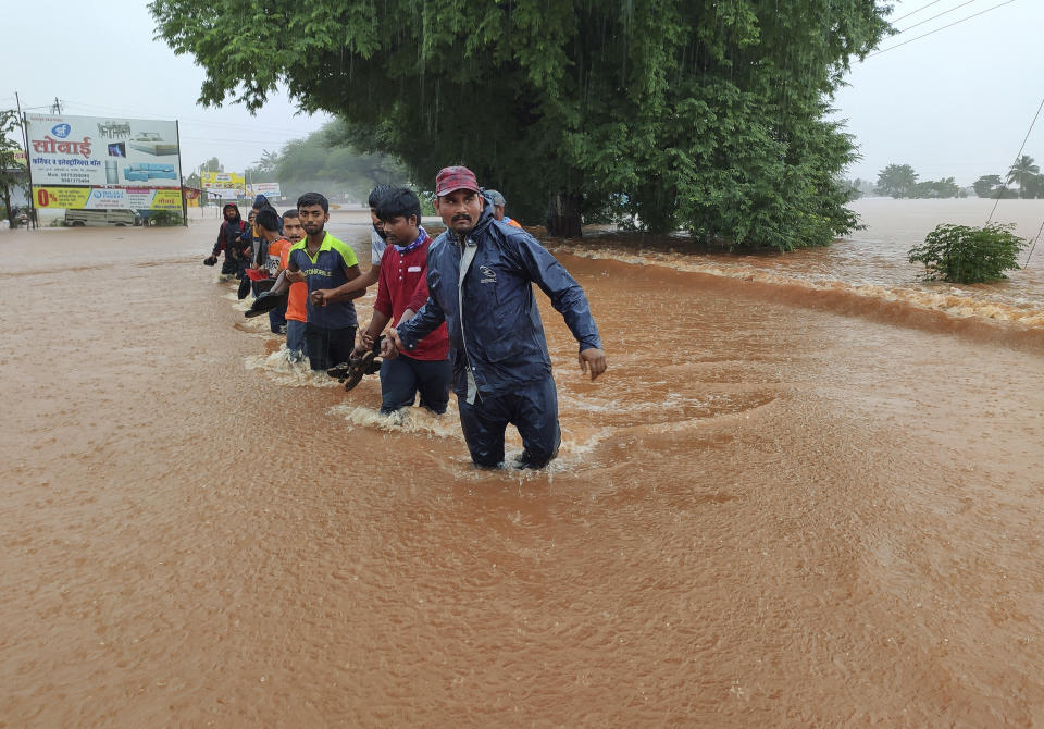 National Disaster Response Force personnel rescue people stranded in floodwaters in Kolhapur, in the western Indian state of Maharashtra, Friday, July 23, 2021. Landslides triggered by heavy monsoon rains hit parts of western India, killing at least 32 people and leading to the overnight rescue of more than 1,000 other people trapped by floodwaters, officials said Friday. (AP Photo)