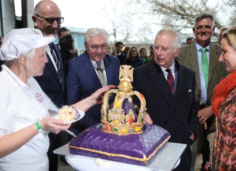 King Charles looks at a cake made specially for his visit in Brodowin ecovillage along with Brandenburg state premier Dietmar Woidke, and German President Frank-Walter Steinmeier (via REUTERS)