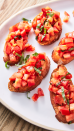 <p>Nothing screams summer quite like bruschetta. Toasted bread gets rubbed with garlic (don't skip it, it's the best part) and topped with simply marinated tomatoes. The brighter and juicier your tomatoes, the better your bruschetta will be.</p><p>Get the <a href="https://www.delish.com/uk/cooking/recipes/a30165416/best-bruschetta-tomato-recipe/" rel="nofollow noopener" target="_blank" data-ylk="slk:Classic Bruschetta;elm:context_link;itc:0;sec:content-canvas" class="link ">Classic Bruschetta</a> recipe.</p>