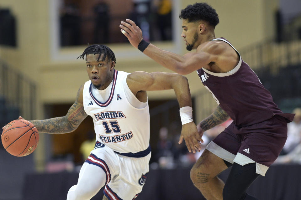 Florida Atlantic guard Alijah Martin (15) drives past Texas A&M guard Jace Carter, right, during the second half of an NCAA college basketball game, Friday, Nov. 24, 2023, in Kissimmee, Fla. (AP Photo/Phelan M. Ebenhack)