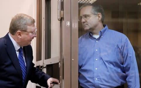 Lawyer Vladimir Zherebenkov speaks to Mr Whelan in the defendant's cage - Credit: Maxim Shemetov/Reuters