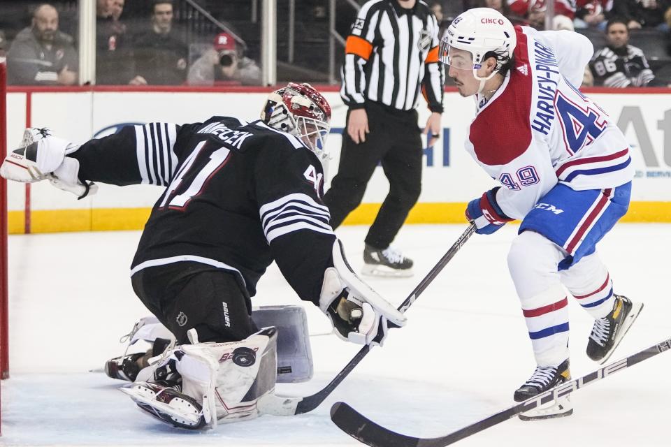 New Jersey Devils goaltender Vitek Vanecek (41) stops a shot on goal by Montreal Canadiens' Rafael Harvey-Pinard (49) during the third period of an NHL hockey game Tuesday, Feb. 21, 2023, in Newark, N.J. The Canadiens won 5-2. (AP Photo/Frank Franklin II)