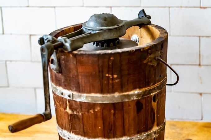 An Old Fashioned Ice Cream Maker With Turning Handle And Makers Mark