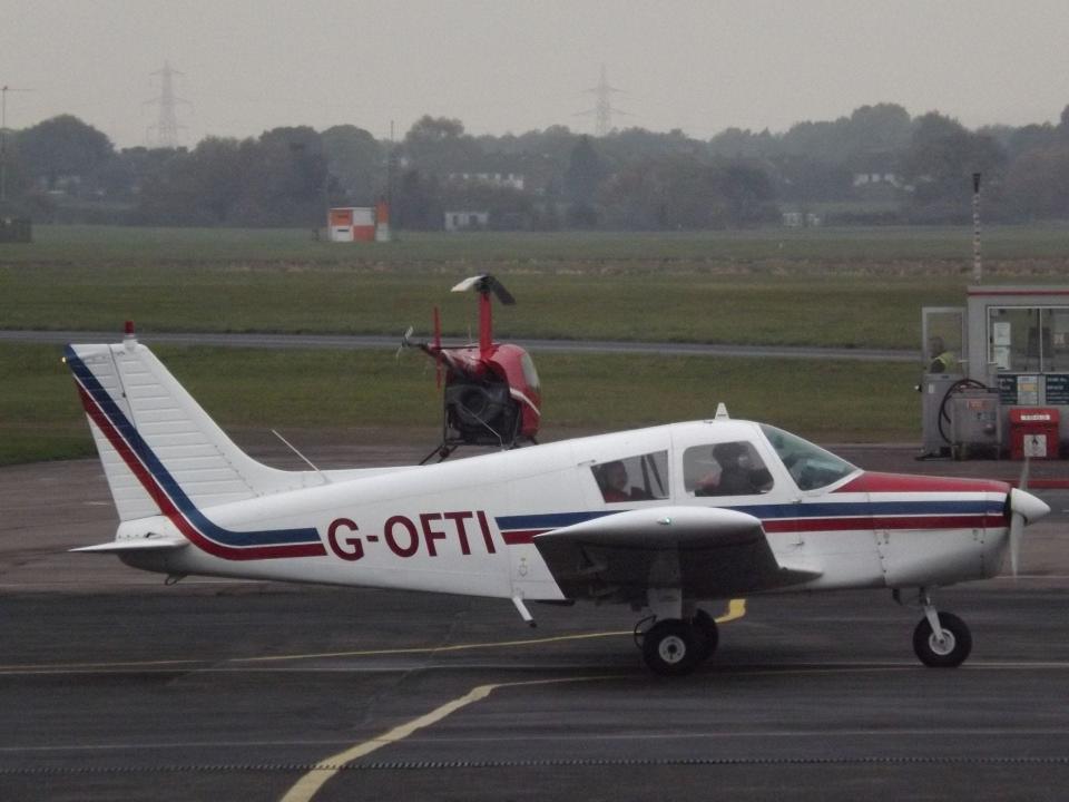 An example of the Piper PA-28 single-engine aircraft, as seen parked on the tarmac at Gloucestershire Airport in England.