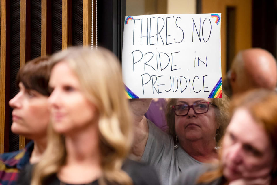 An attendee holds up a sign outside the meeting room during a Grapevine-Colleyville Independent School District school board meeting in Grapevine, Texas on Aug. 22, 2022. (Emil Lippe for NBC News file)