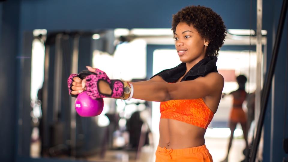  Woman holding kettlebell 