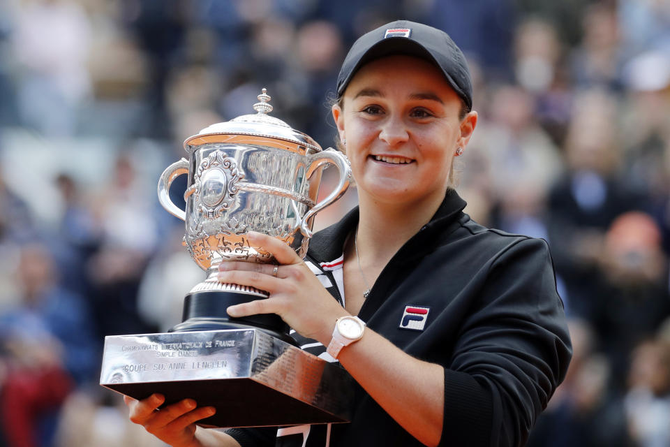 FILE - In this June 8, 2019, file photo, Australia's Ashleigh Barty holds the trophy as she celebrates after defeating Marketa Vondrousova, of the Czech Republic, in the women's final of the French Open tennis tournament at the Roland Garros stadium in Paris. Barty is ready to cap off the most successful season of her career with a first appearance in the year-end WTA Finals. (AP Photo/Christophe Ena, File)