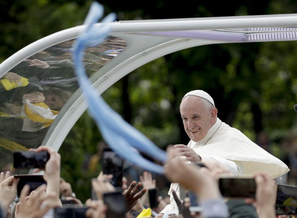 Pope Francis is driven through the crowd as he arrives for a meeting with young people and families, in Iasi, Romania, Saturday, June 1, 2019. Francis began a three-day pilgrimage to Romania on Friday that in many ways is completing the 1999 trip by St. John Paul II that marked the first-ever papal visit to a majority Orthodox country. (AP Photo/Andrew Medichini)