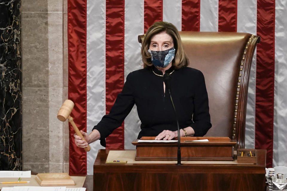 Speaker of the House Nancy Pelosi, D-Calif., gavels in the final vote of the impeachment of President Donald Trump, for his role in inciting an angry mob to storm the Congress last week, at the Capitol in Washington, Wednesday, Jan. 13, 2021. (AP Photo/J. Scott Applewhite)