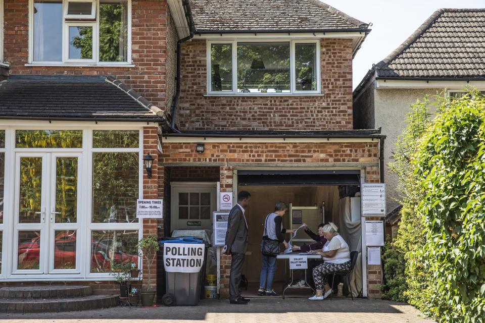 CROYDON, ENGLAND - MAY 23: Members of the public cast their vote at a polling station in a garage in Croydon on May 23, 2019 in London, United Kingdom.  Polls are open for the European Parliament elections. Voters will choose 73 MEPs in 12 multi-member regional constituencies in the UK with results announced once all EU nations have voted. (Photo by Dan Kitwood/Getty Images)