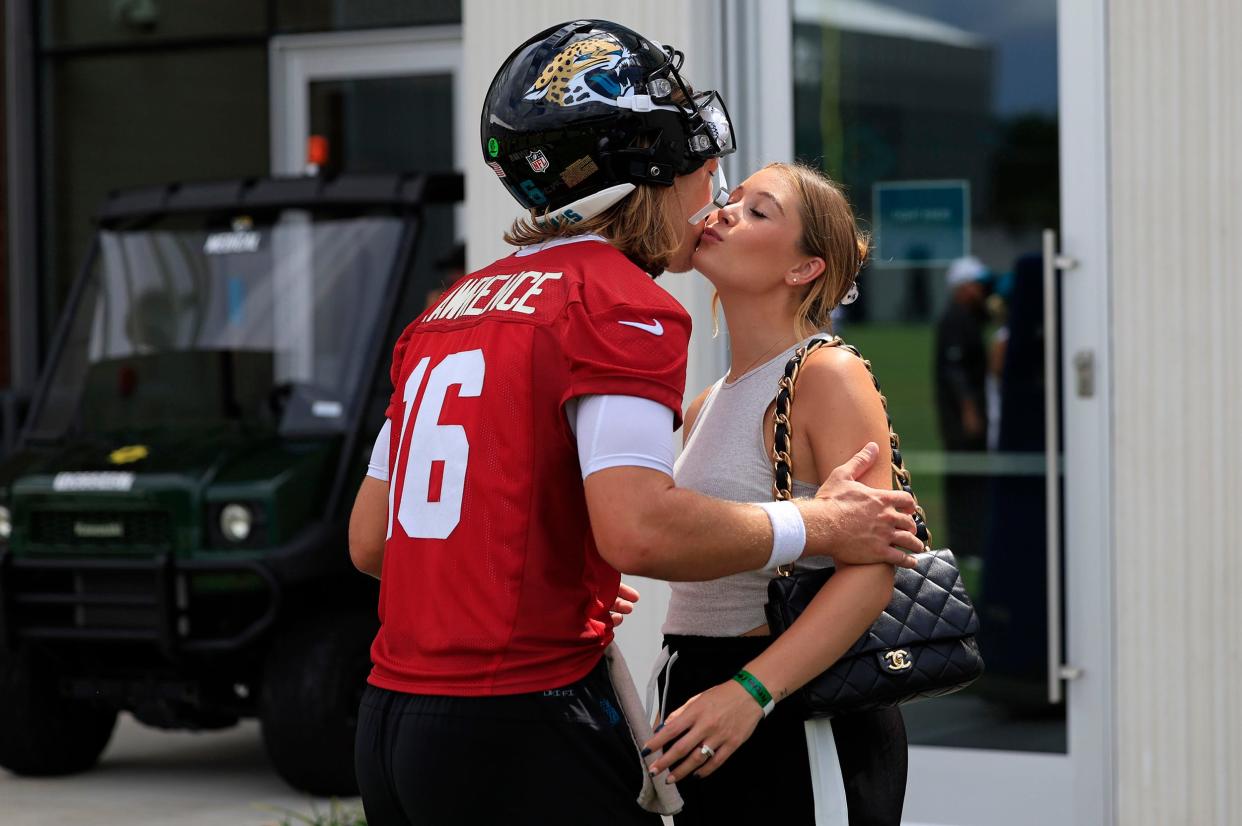 Jacksonville Jaguars quarterback Trevor Lawrence (16) kisses his wife Marissa Lawrence after a combined NFL football training camp session between the Tampa Bay Buccaneers and Jacksonville Jaguars Thursday, Aug. 15, 2024 at EverBank Stadium’s Miller Electric Center in Jacksonville, Fla.