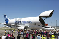 <p>The engineers wave from the deck of the Airbus BelugaXL after successfully completing its first flight at Toulouse-Blagnac airport, in Toulouse, southern France, Thursday, July 19, 2018. The flight will kick off a 10-month flight test certification campaign leading to planned service entry in 2019. (AP Photo/Frederic Scheiber) </p>