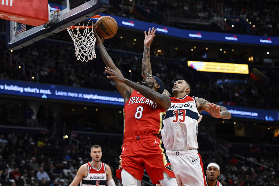 New Orleans Pelicans forward Naji Marshall (8) goes to the basket for a layup against Washington Wizards forward Kyle Kuzma (33) during the first quarter of an NBA basketball game, Monday, Jan. 9, 2023, in Washington. (AP Photo/Terrance Williams)