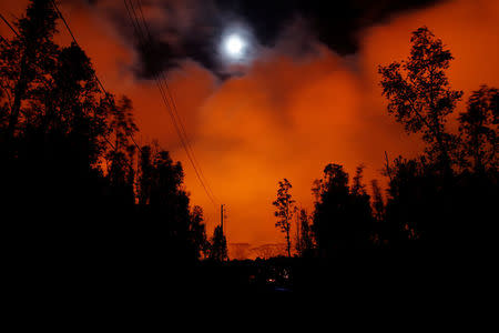 A lava flow from the Kilauea volcano illuminated the night sky, in the Leilani Estates near Pahoa, Hawaii, U.S., May 26, 2018. REUTERS/Marco Garcia