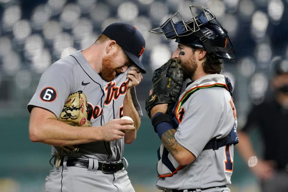 Detroit Tigers starting pitcher Spencer Turnbull, left, and catcher Eric Haase meet on the mound after Turnbull walked in a run during the first inning of the team's baseball game against the Kansas City Royals on Friday, Sept. 25, 2020, in Kansas City, Mo.