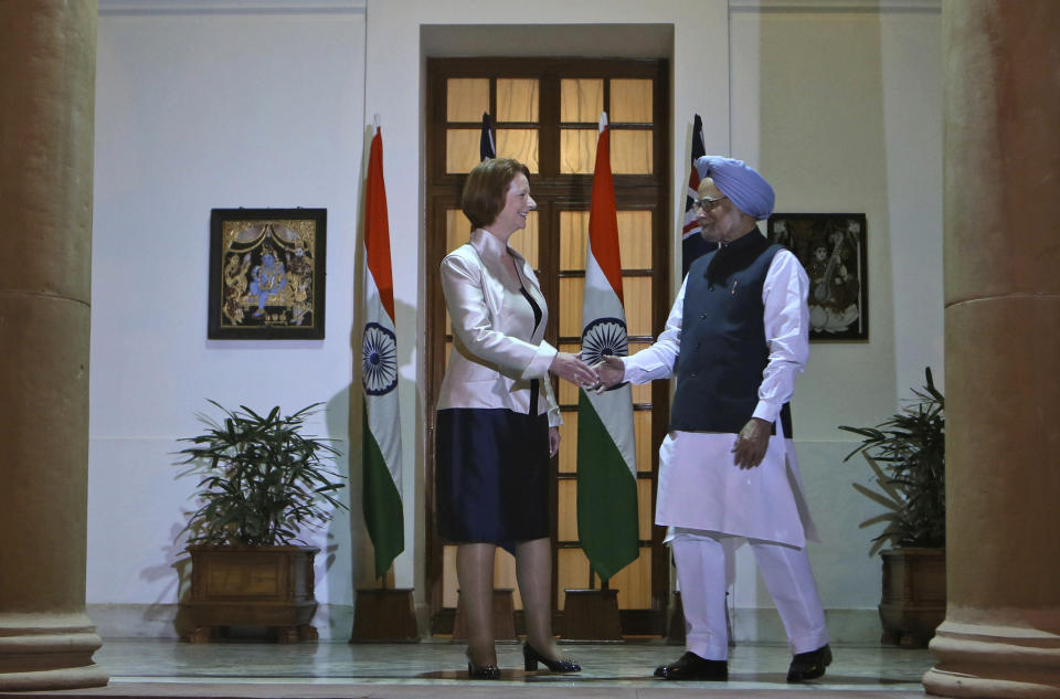 Australian Prime Minister Julia Gillard, left, shakes hands with Indian Prime Minister Manmohan Singh before a meeting in New Delhi, India, Wednesday, Oct. 17, 2012. India and Australia began talks Wednesday to strengthen economic and strategic ties and explore cooperation in civilian nuclear energy. (AP Photo/ Manish Swarup)