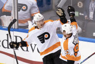 Philadelphia Flyers defenseman Philippe Myers (5) celebrates his goal with right wing Jakub Voracek (93) against the Boston Bruins during second-period NHL hockey playoff action in Toronto, Sunday, Aug. 2, 2020. (Frank Gunn/The Canadian Press via AP)