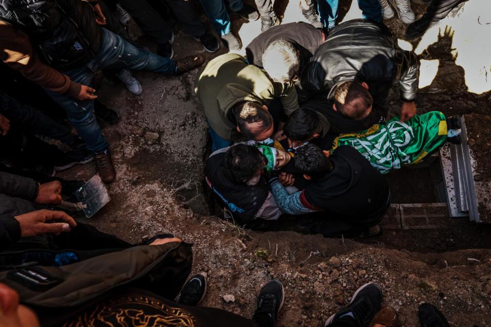 Family members bury Amro Najjar.