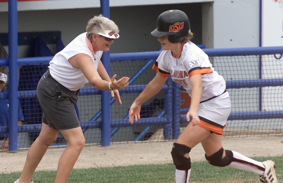 Then-OSU softball coach Sandy Fischer congrats Jade Lindly after her home run in the 2001 Big 12 tournament game.