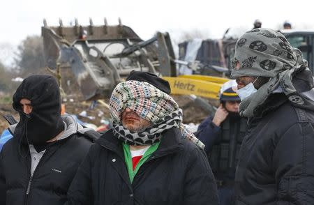 Iranian migrants, with their lips sewn, attend a protest against the partial dismantlement of the camp for migrants called the "Jungle", in Calais, France, March 3, 2016. REUTERS/Yves Herman