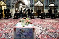 A coffin with an image of Iranian nuclear scientist Mohsen Fakhrizadeh, can be seen among the servants of the holy shrine of Imam Reza in Mashhad