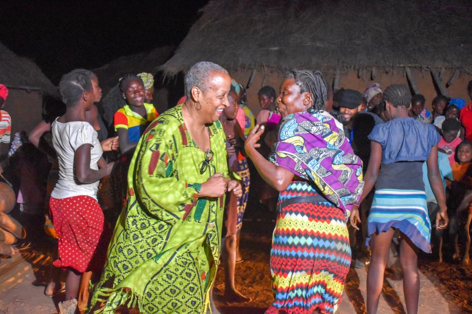 Wanda Tucker and a village elder dance to the sounds of the marimba in Mufuma, Angola. 