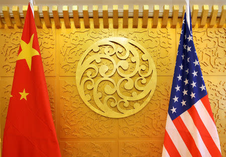 FILE PHOTO: Chinese and U.S. flags are set up for a meeting during a visit by U.S. Secretary of Transportation Elaine Chao at China's Ministry of Transport in Beijing, China April 27, 2018. Picture taken April 27, 2018. REUTERS/Jason Lee/File Photo